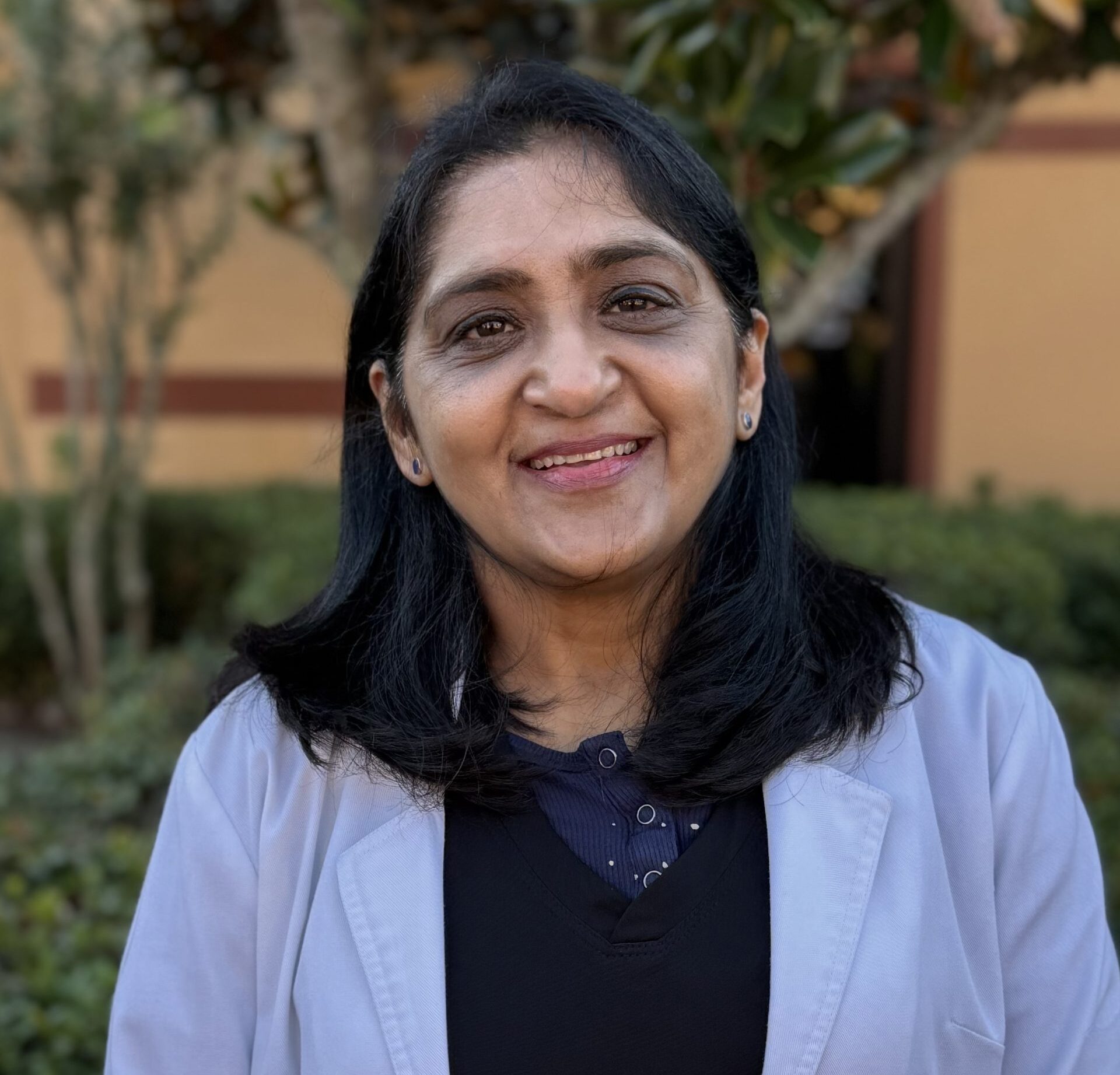 Dr. Pranati Chokshi, smiling outside of their Winter Garden, FL clinic