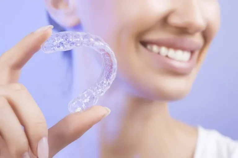 Dental implant replacing a missing tooth beside healthy gums and natural teeth